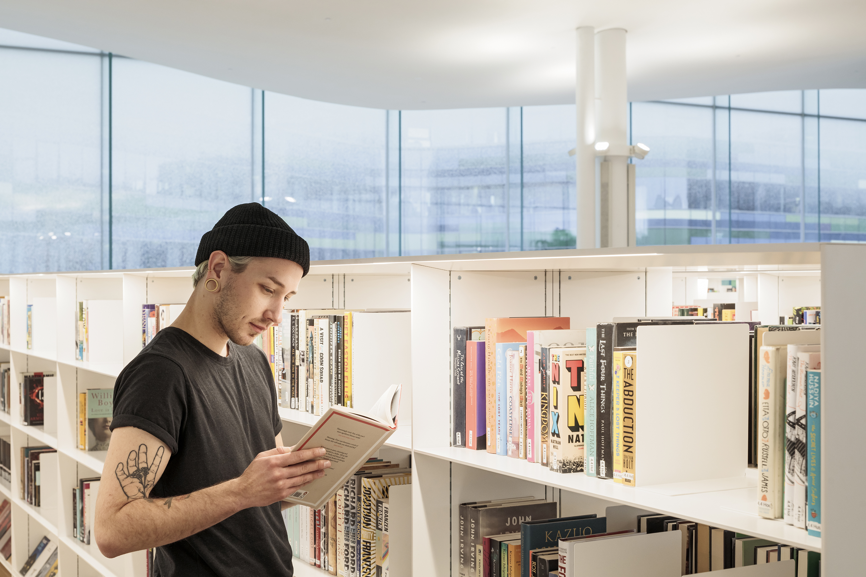 Young man studying a book at the Oodi library in Helsinki. Photo: Kuvio