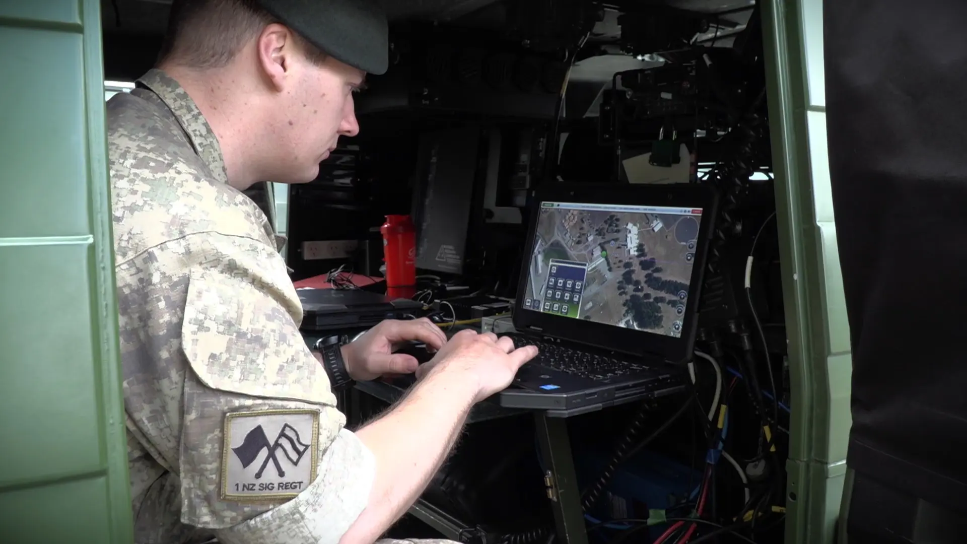 Soldier looking at SitaWare in a van