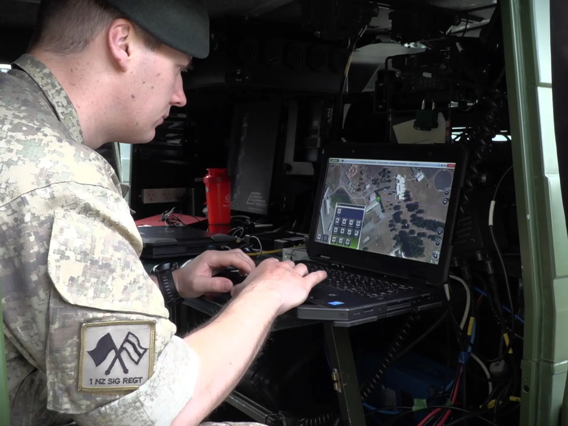 Soldier looking at SitaWare in a van