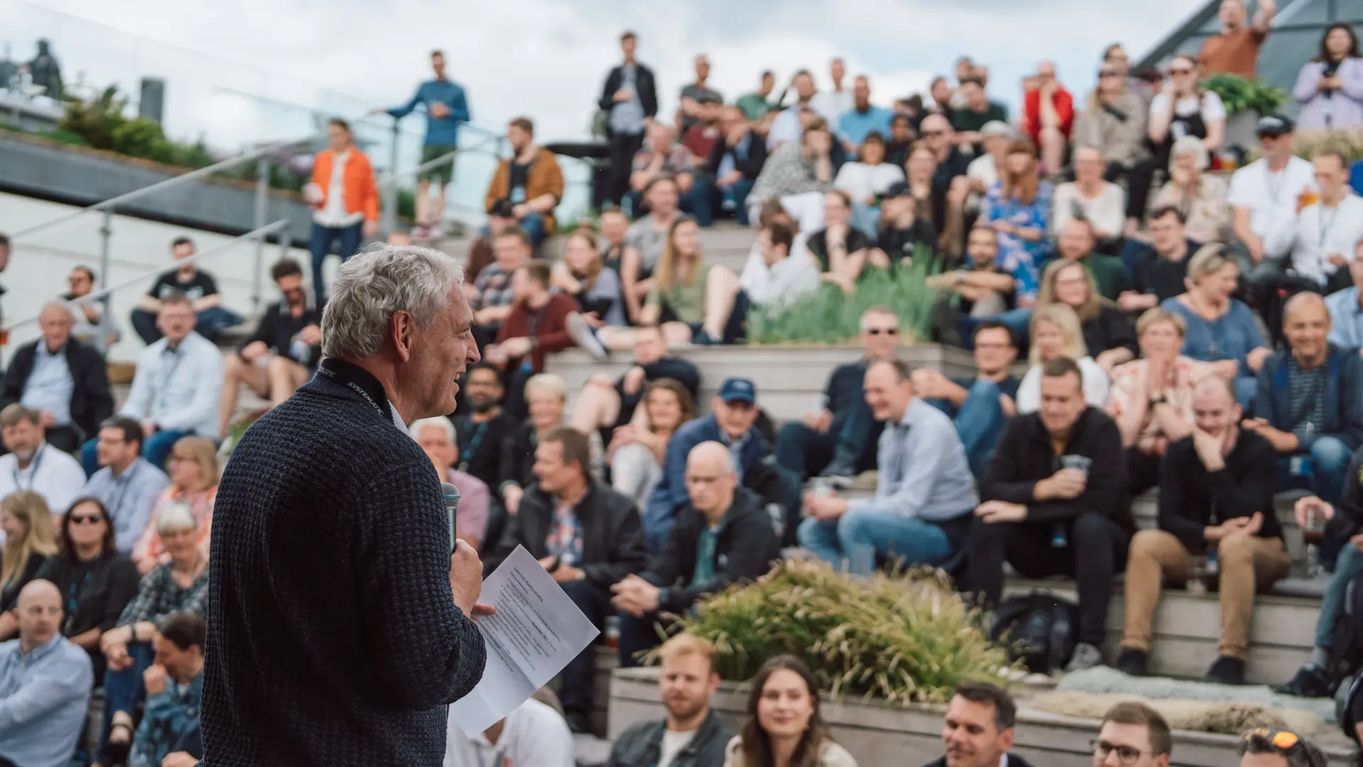 Michael Holm addresses Systematic employees at a venue in Aarhus