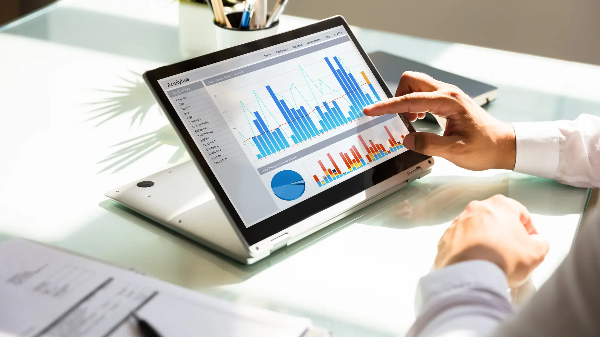 Man points to graphs on iPad