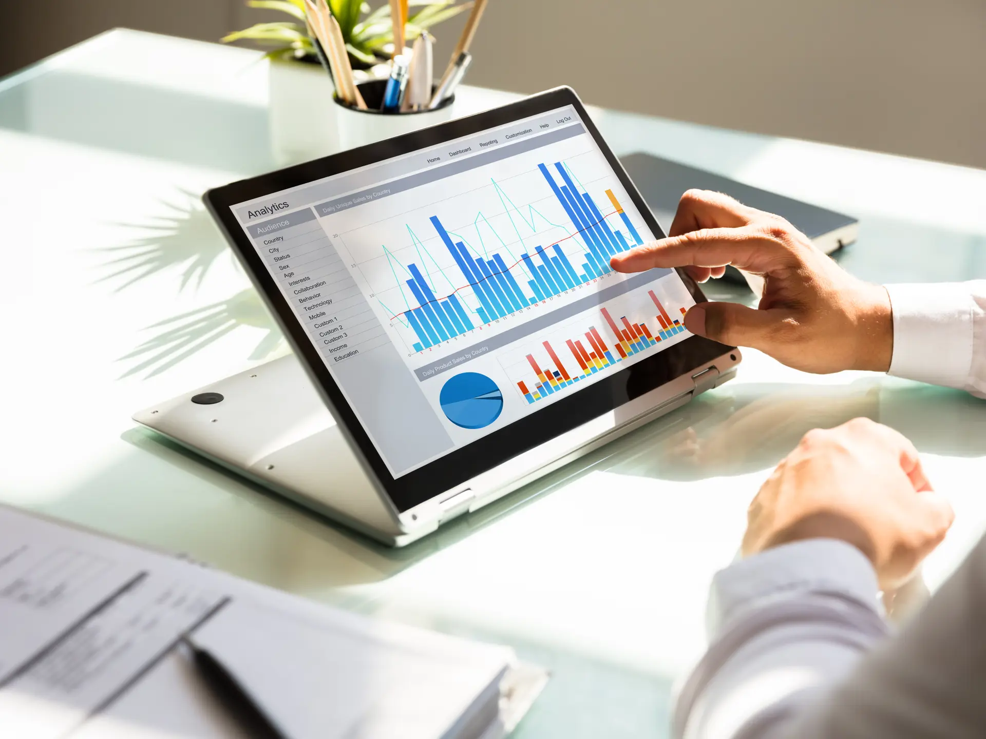 Man points to graphs on iPad