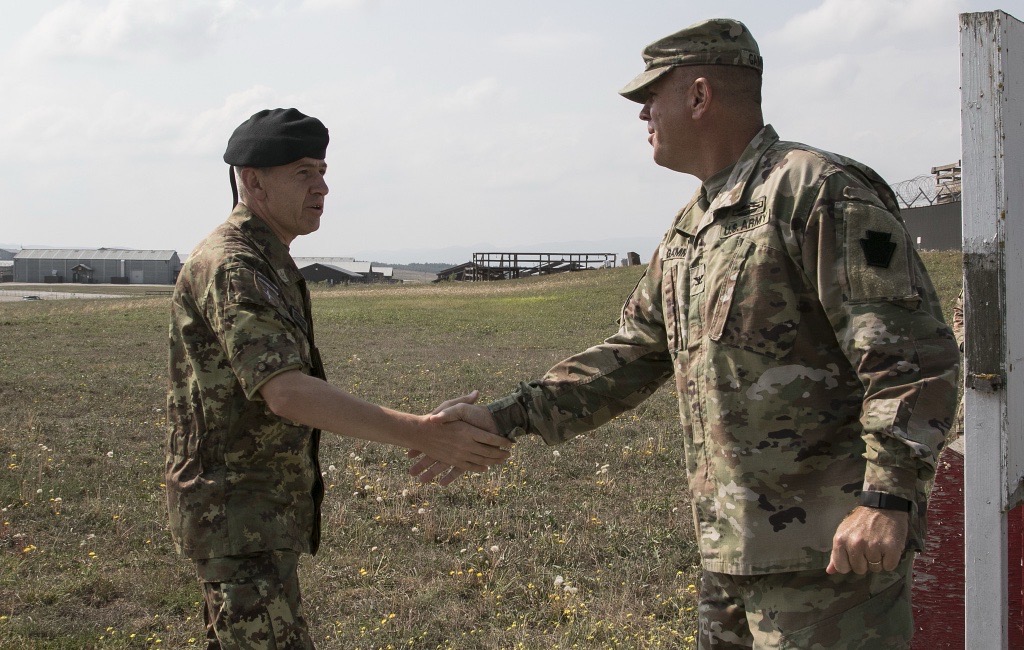 Image of Ros Gammon shaking hands with the Command of KFOR and Camp Bondsteel in Kosovo
