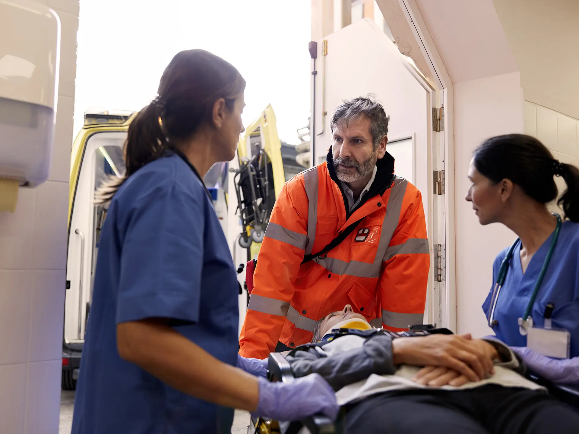 Two nurses and a paramedic with a patient