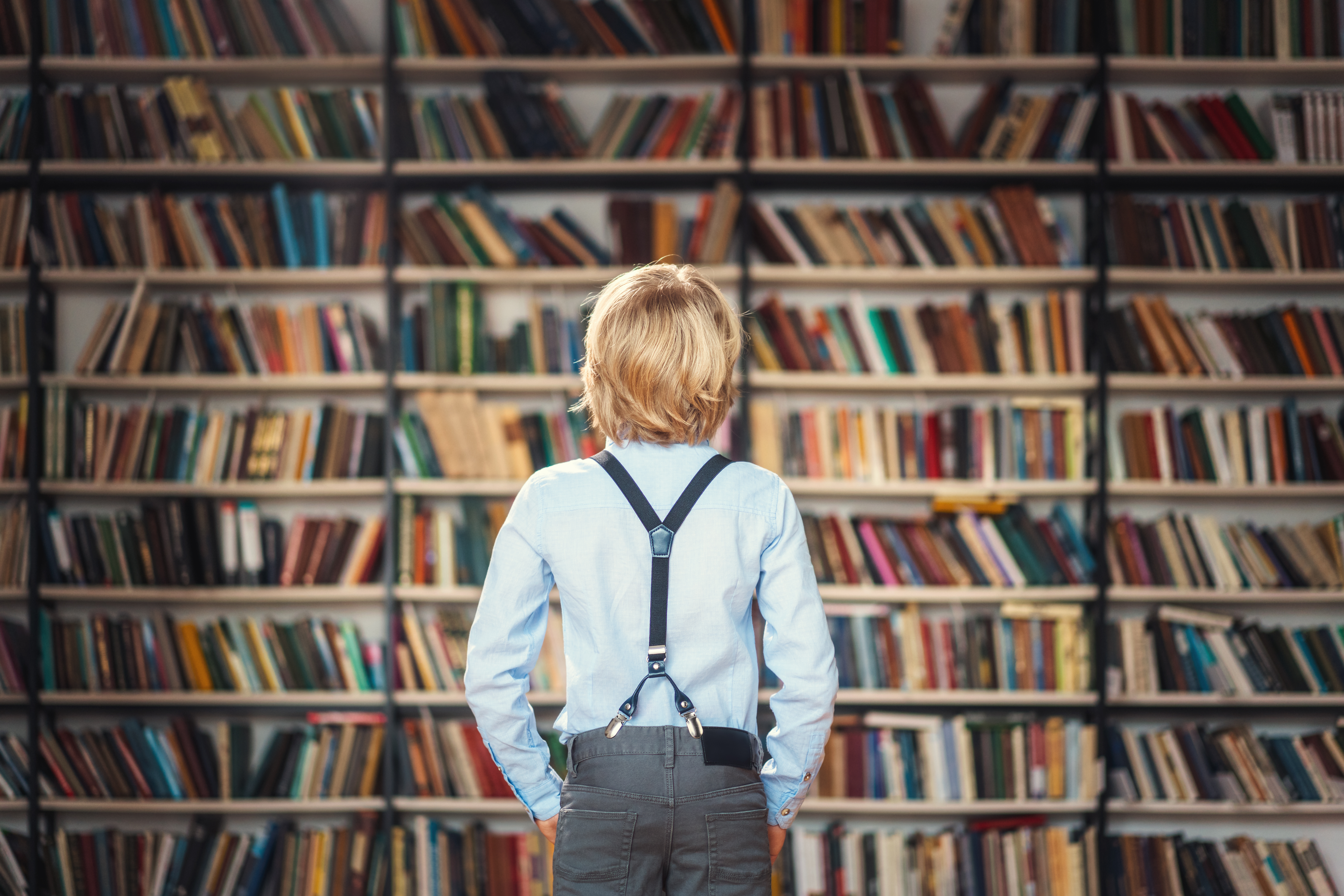 Boy In Front Of Bookshelf