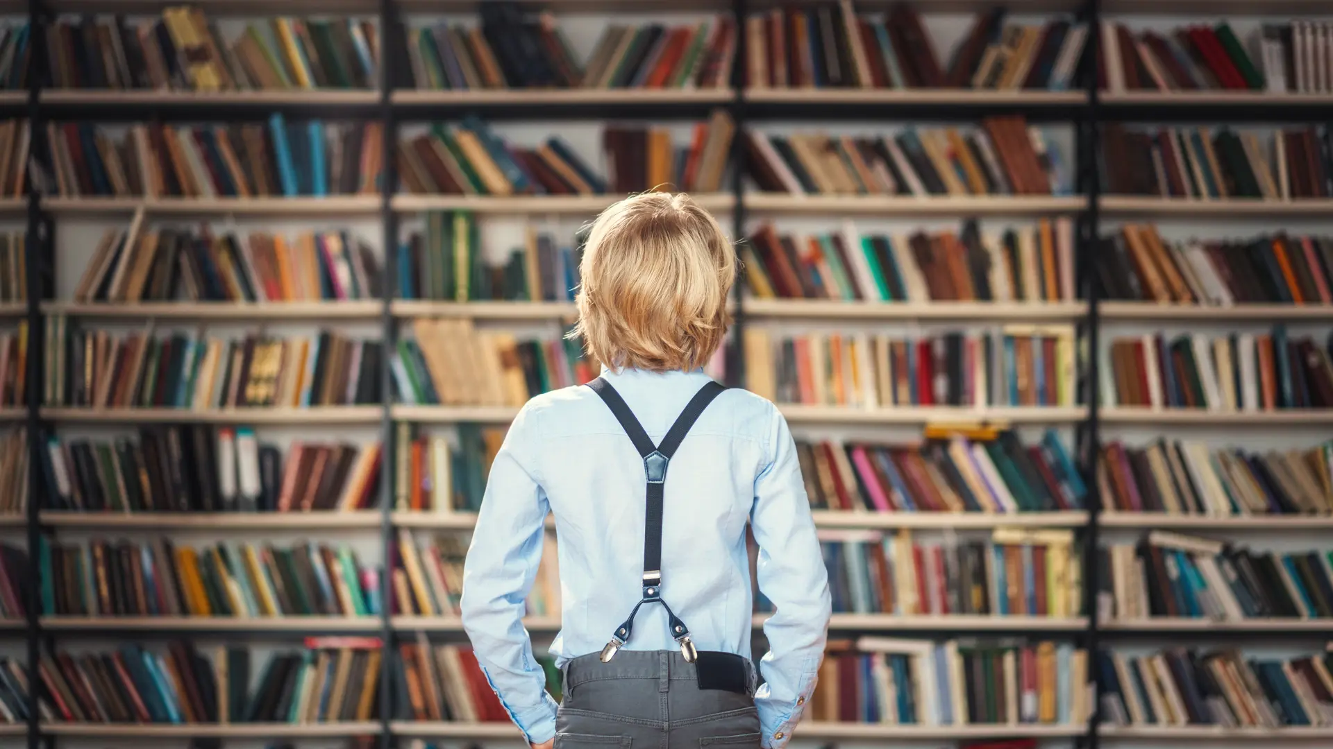 Boy In Front Of Bookshelf