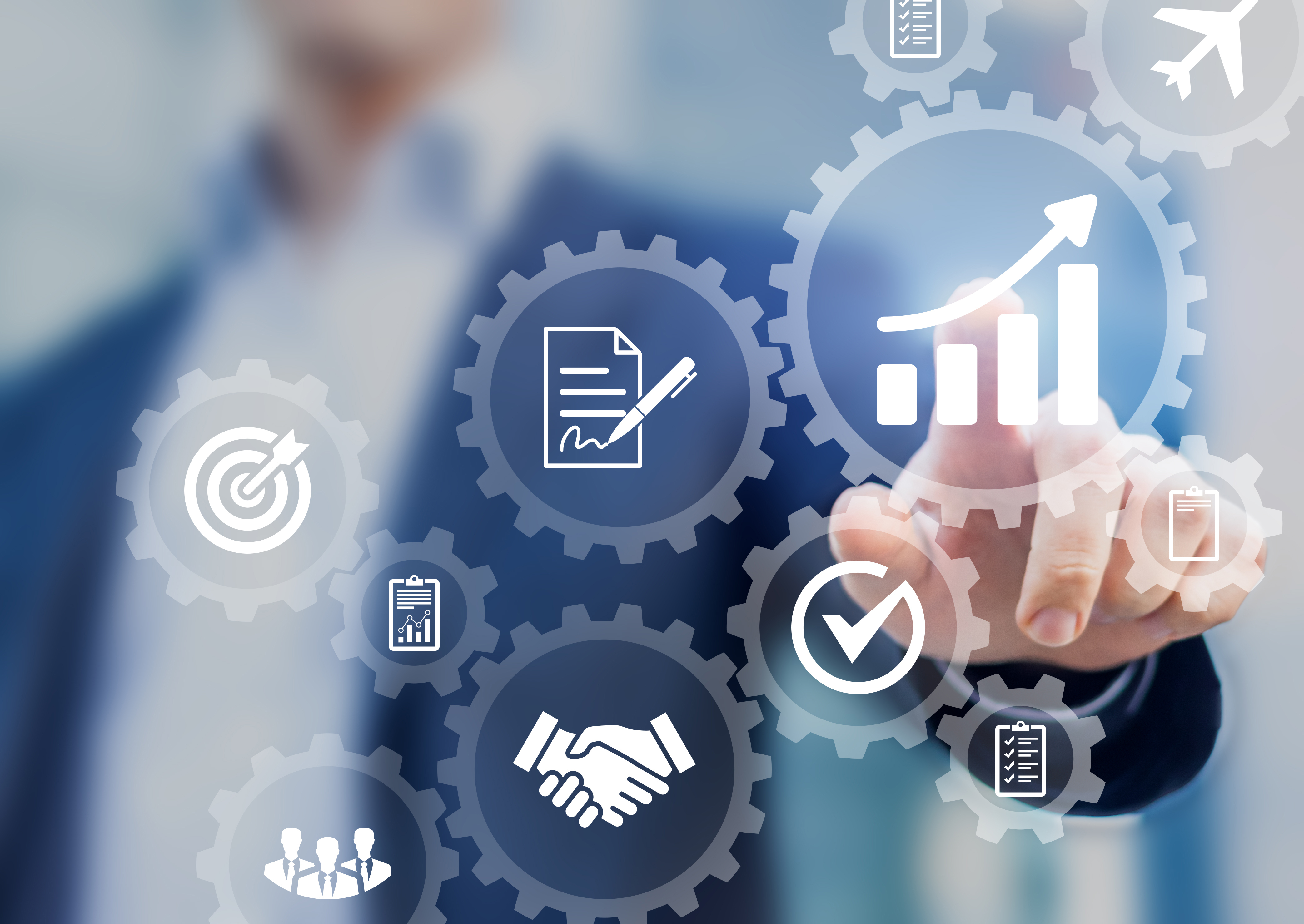 Man in suit pointing at a screen