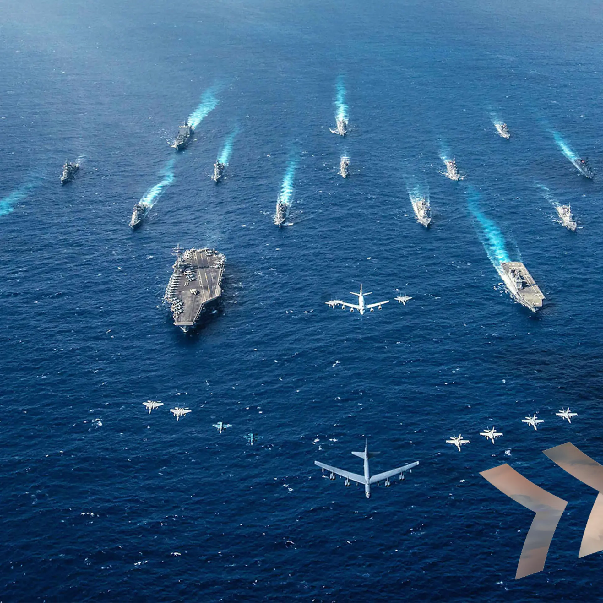 Naval fleet in formation sails across open sea with military aircraft flying overhead in coordinated formation.