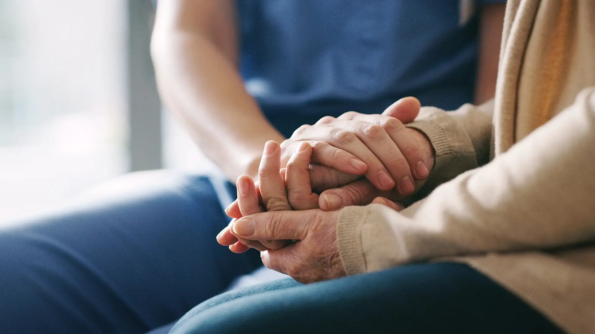 Nurse holding patient's hand