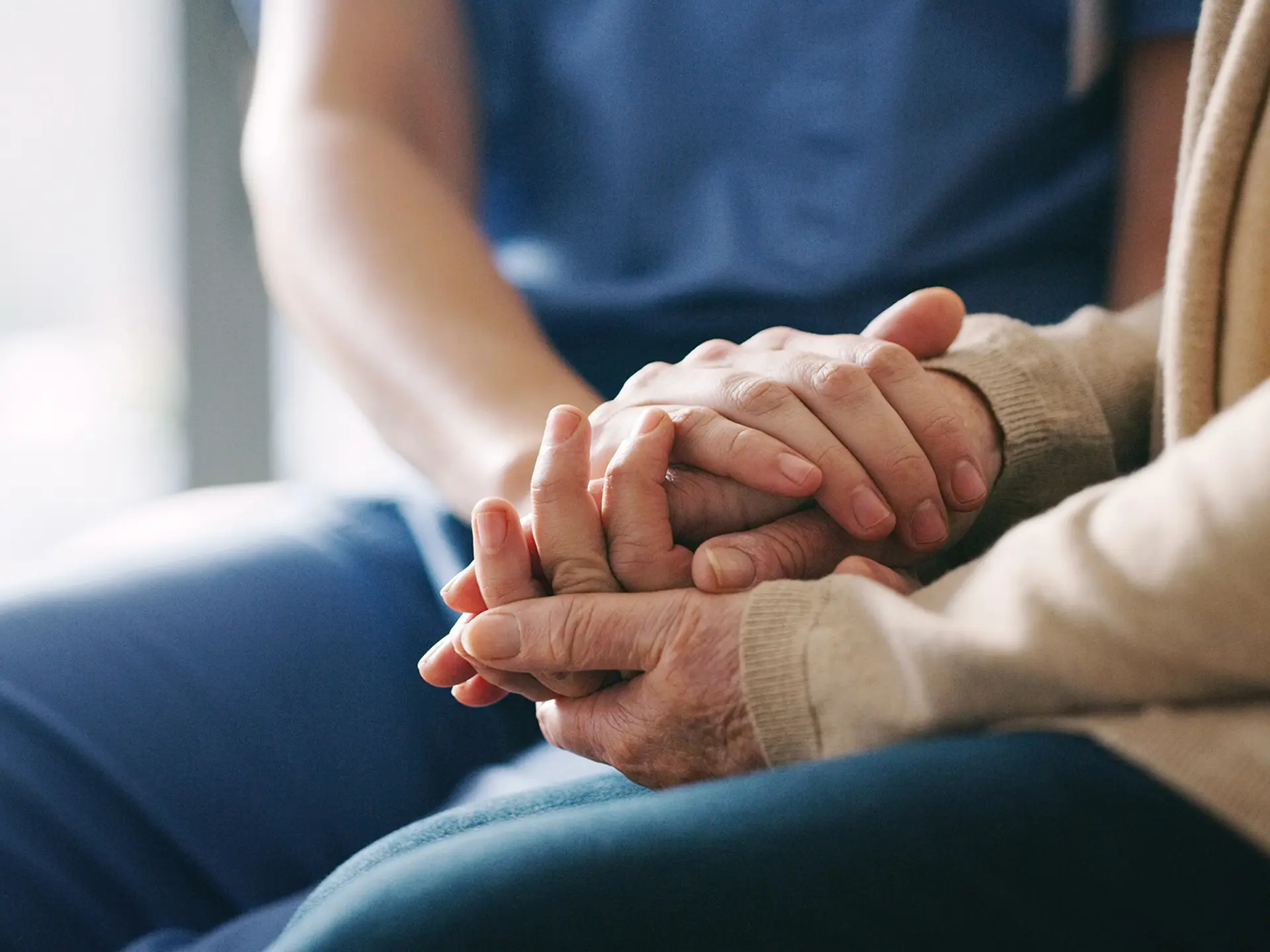 Nurse holding patient's hand