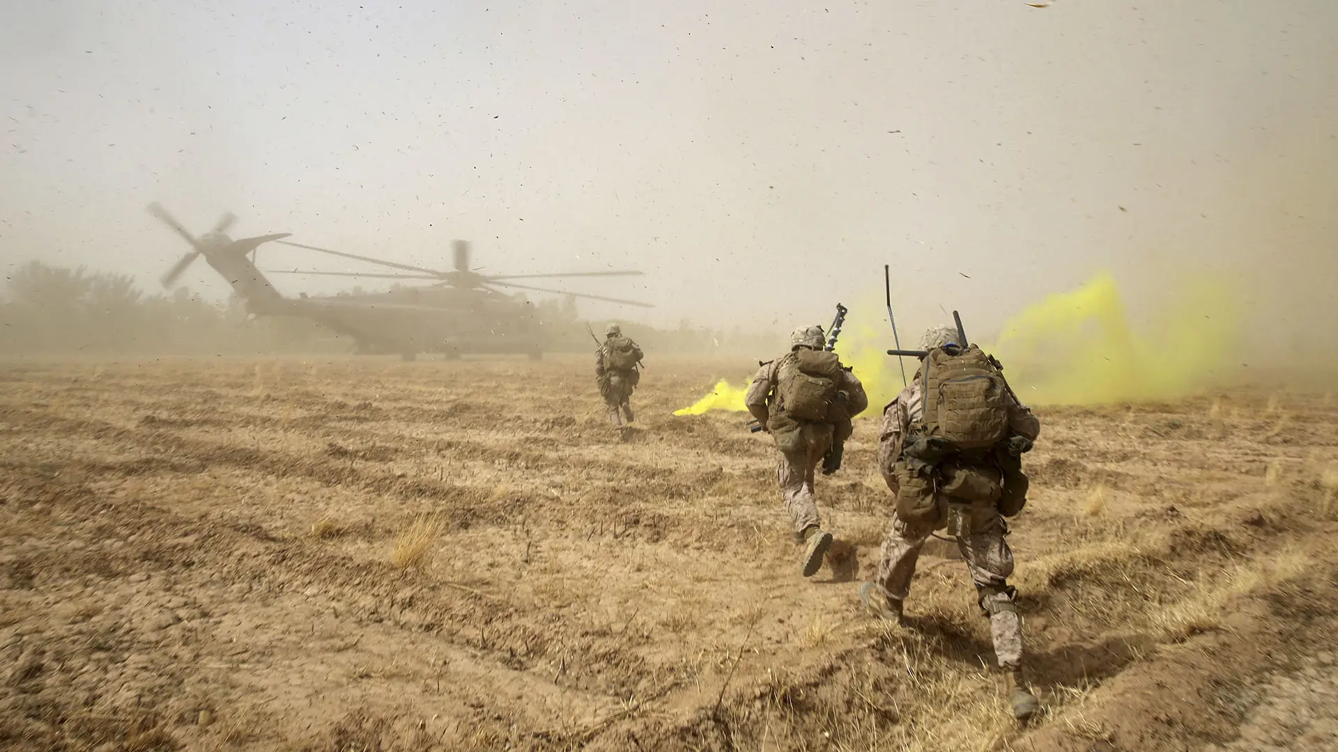 US Marines Sprinting Across Field Towards Super Stallion