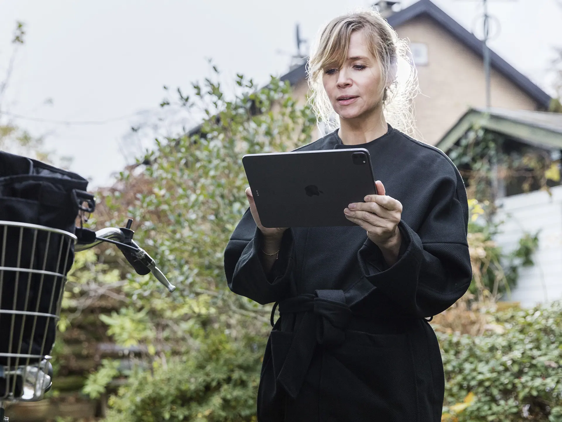 Social worker using tablet with bike