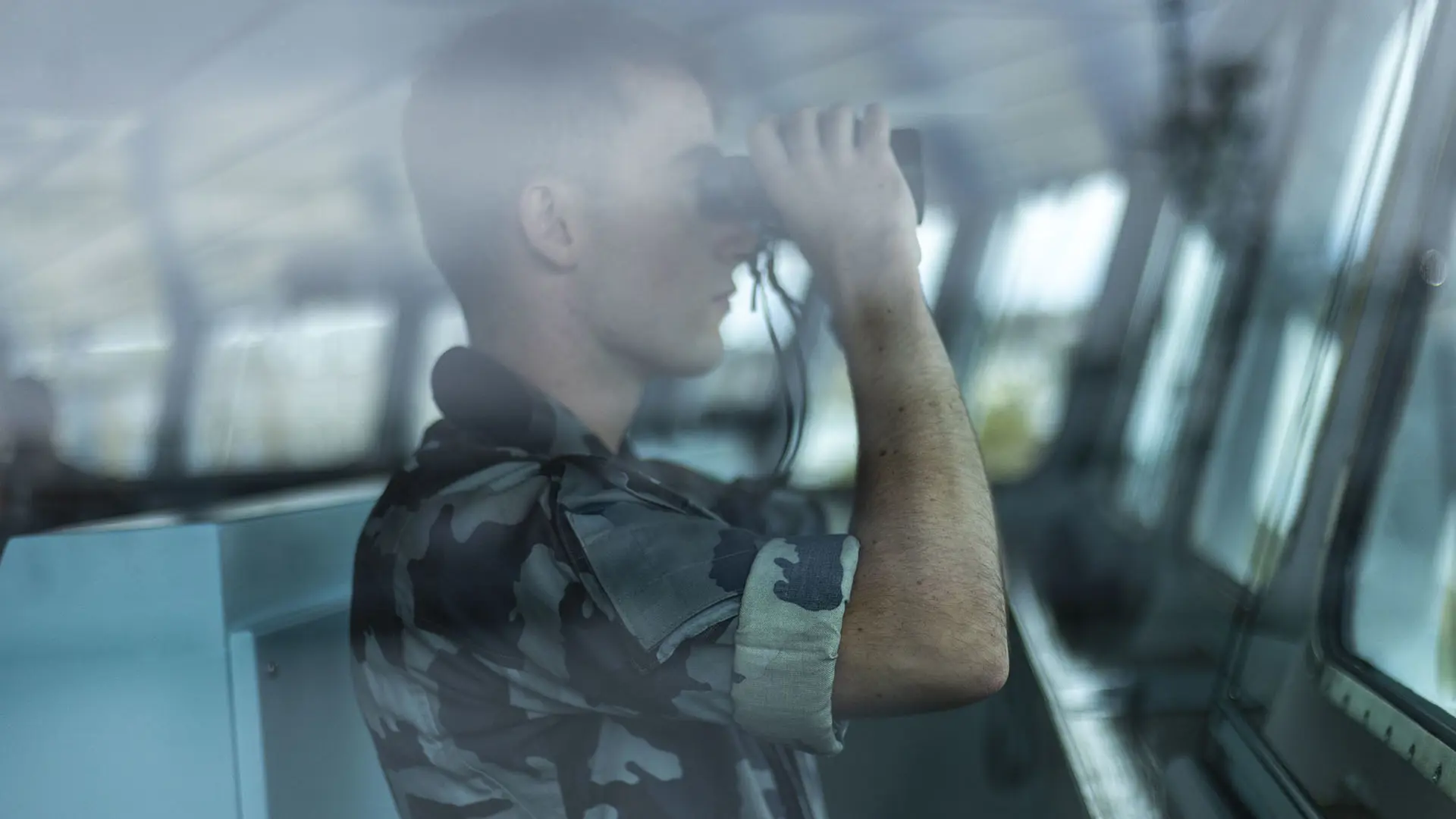 Naval officer looking through binoculars  