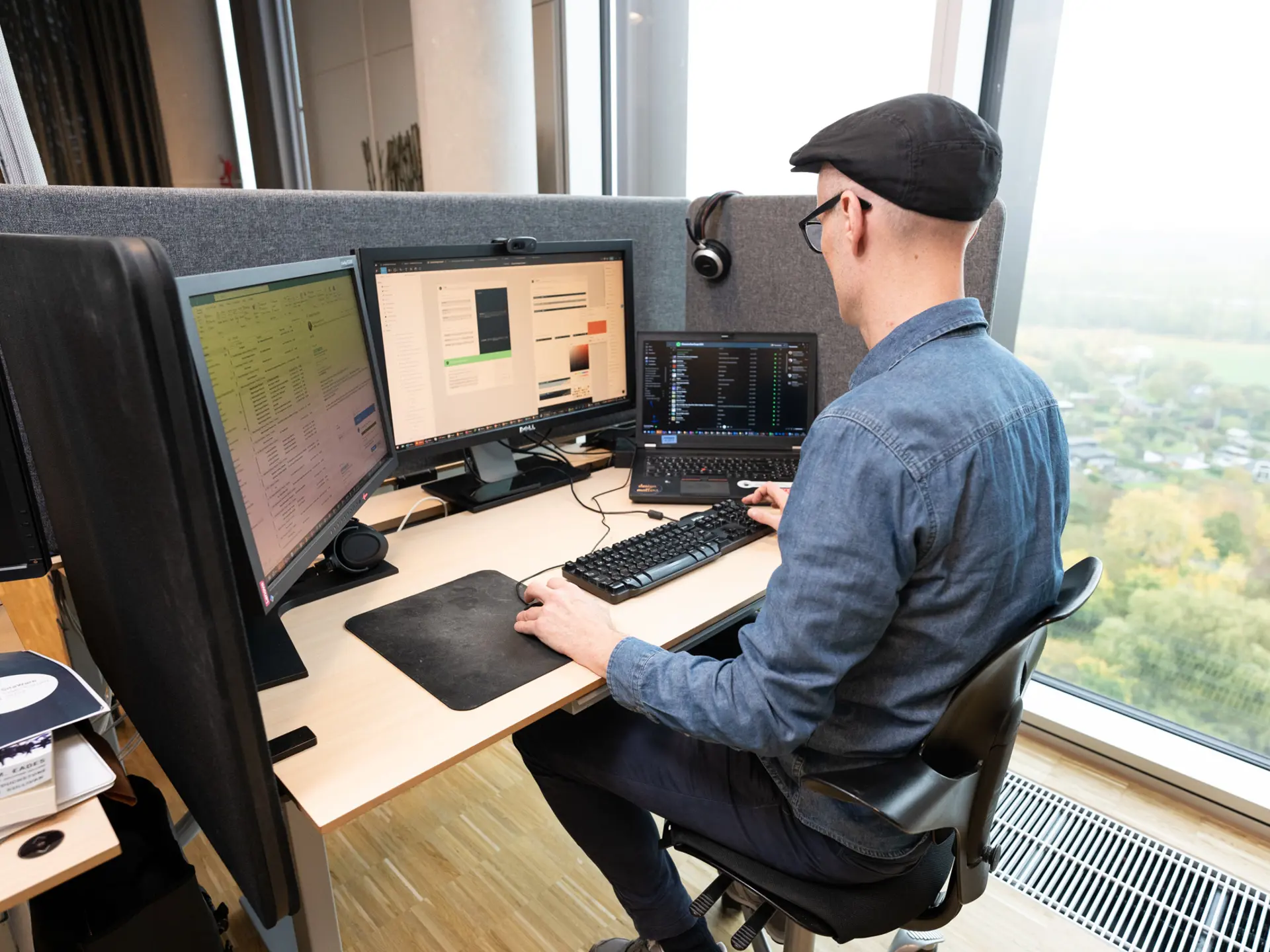 Employee working at computer with software development