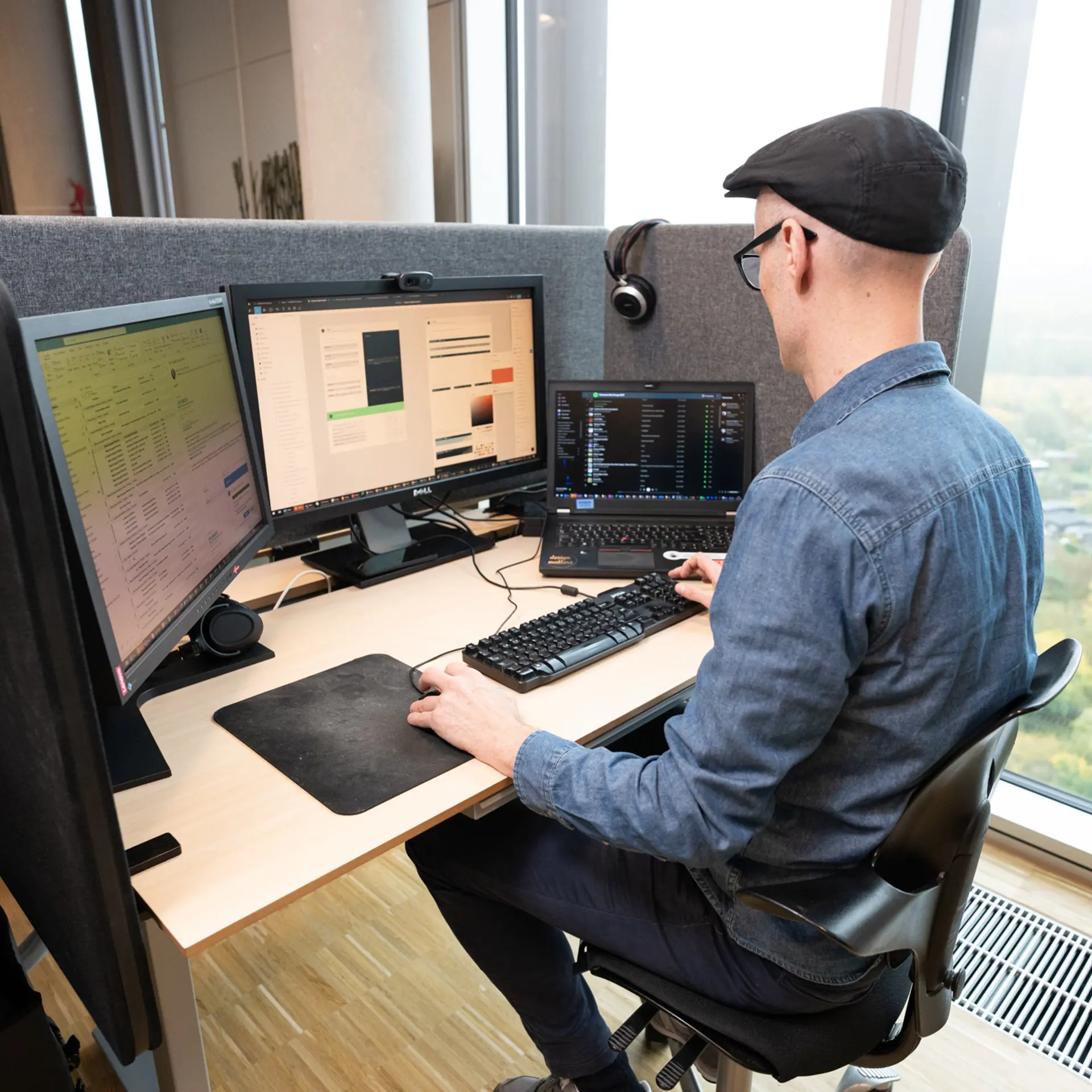 Employee working at computer with software development