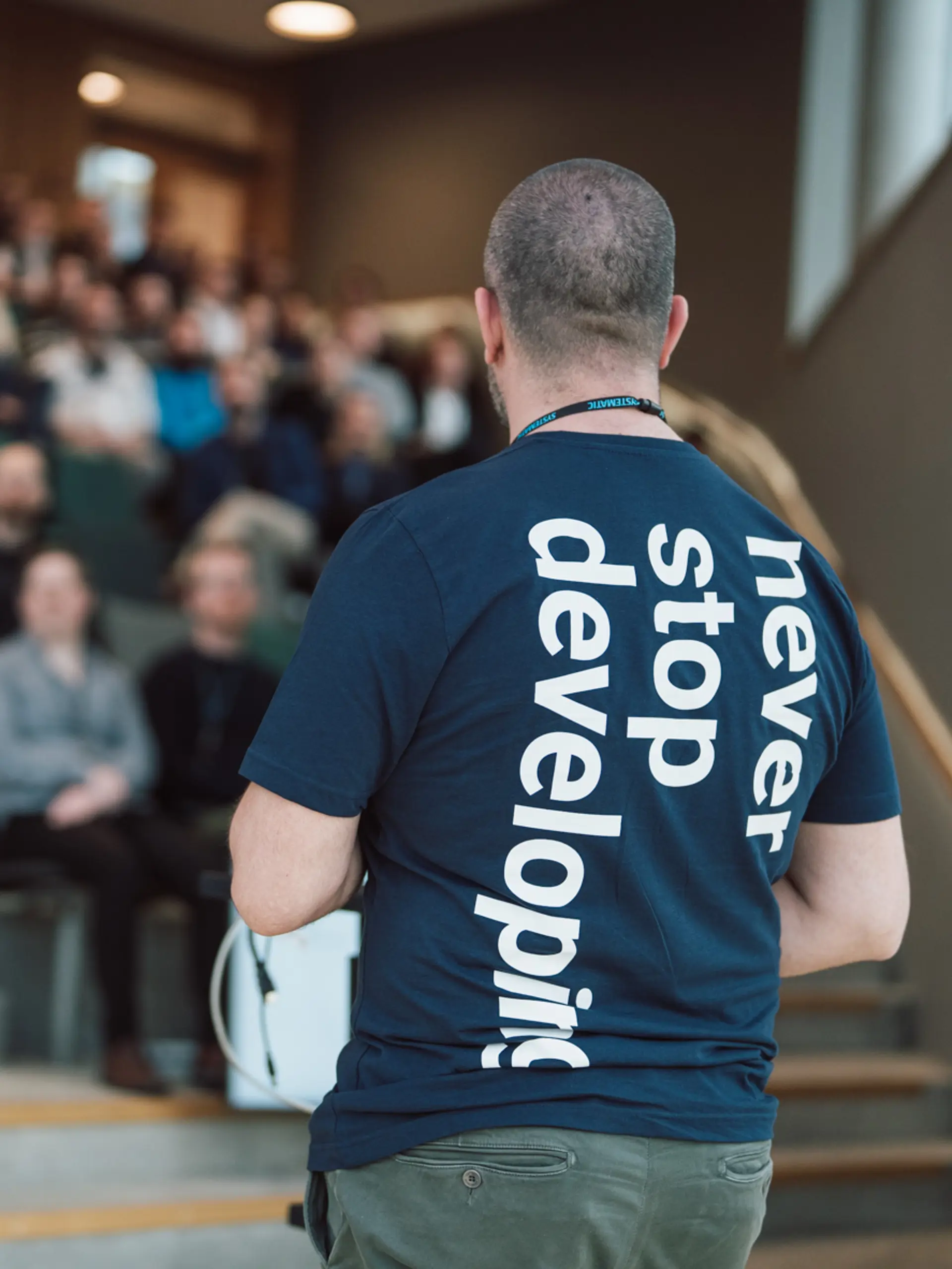 Nikolaj Bramsen with Never Stop Developing t-shirt at Company Briefing