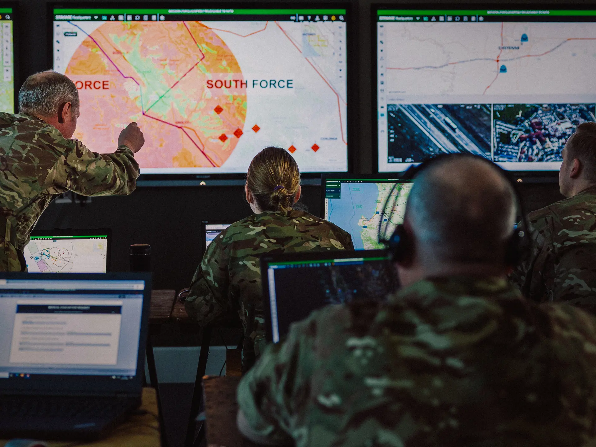 Image of personnel in a headquarters situation room looking at SitaWare software