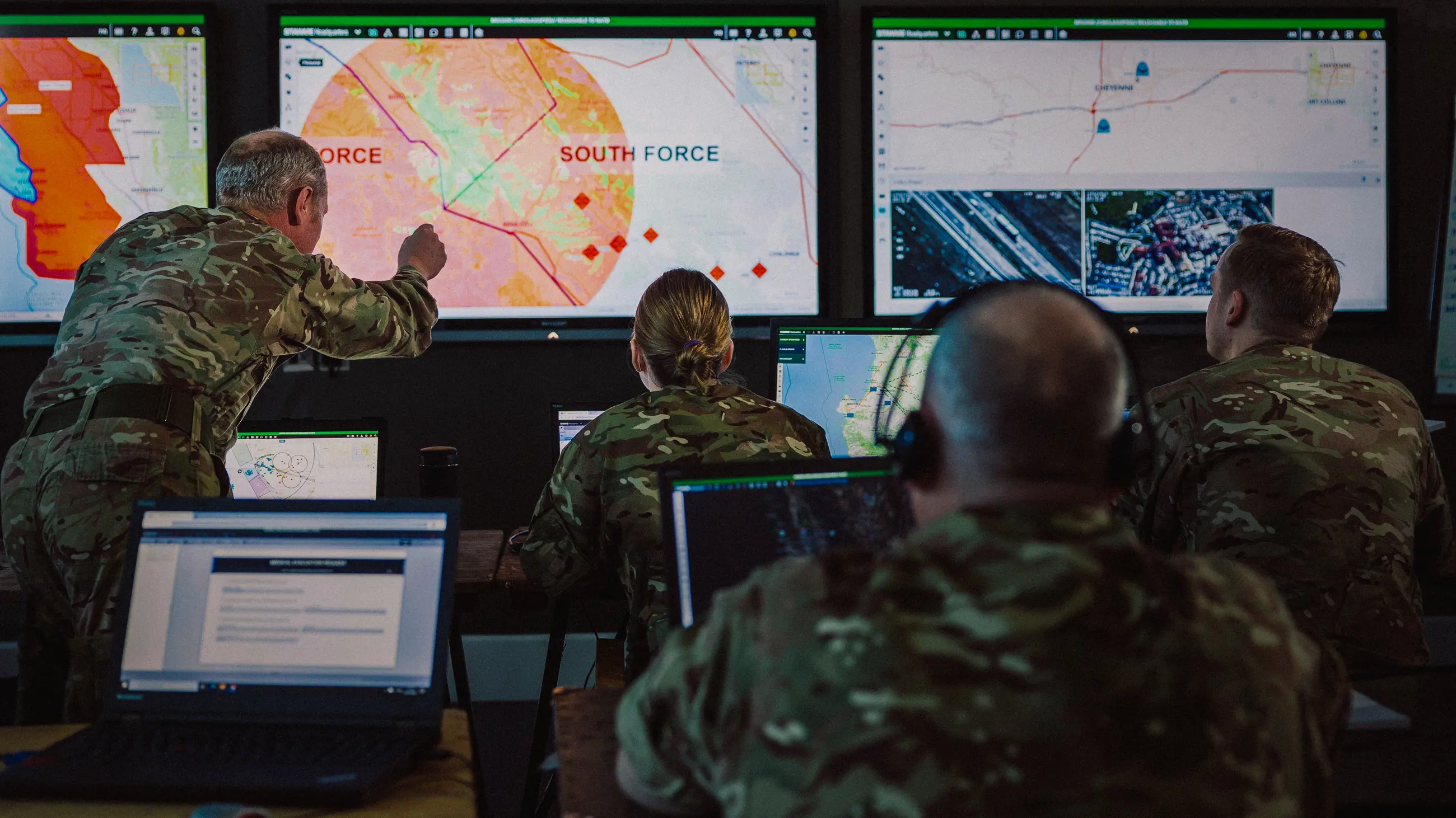 Image of personnel in a headquarters situation room looking at SitaWare software