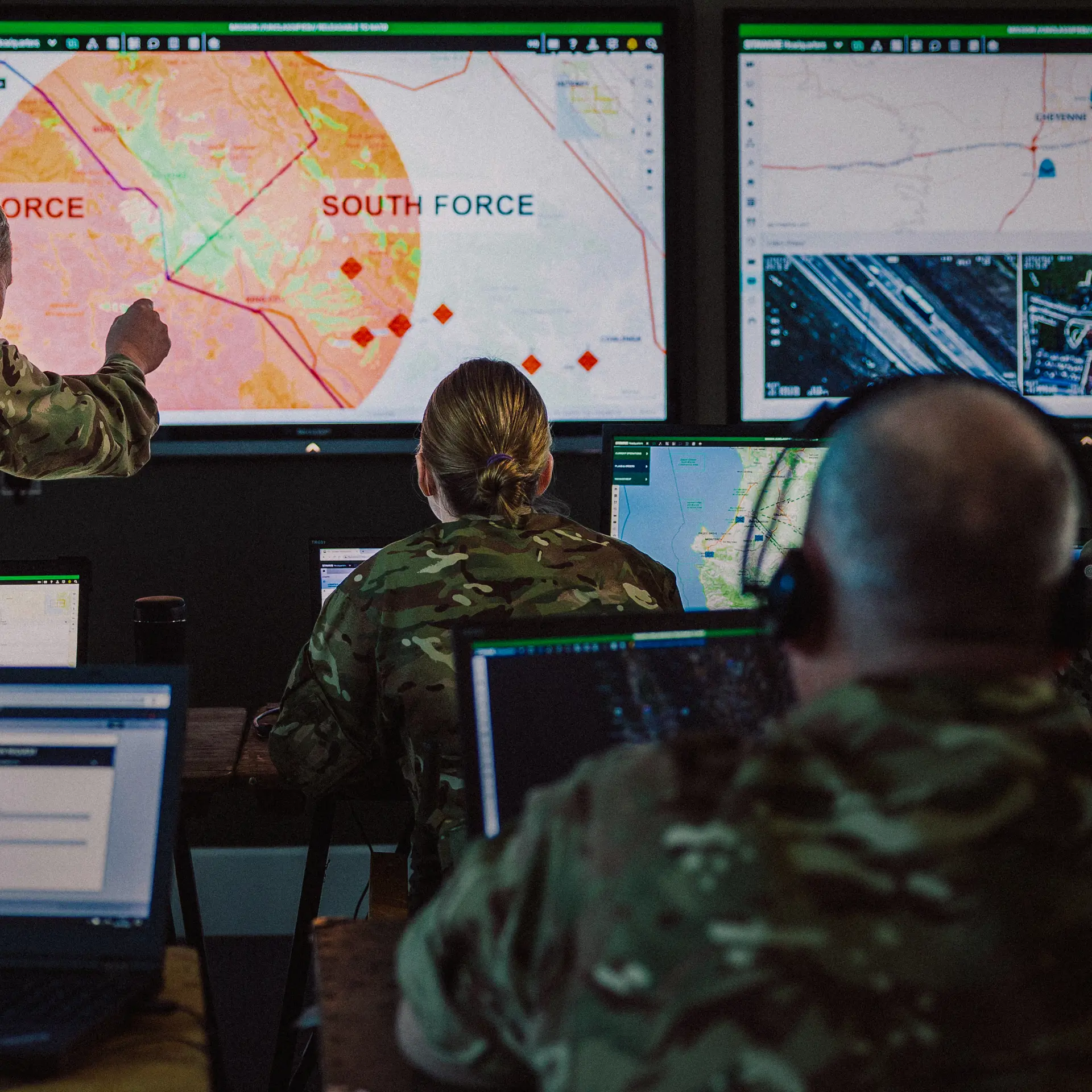 Image of personnel in a headquarters situation room looking at SitaWare software