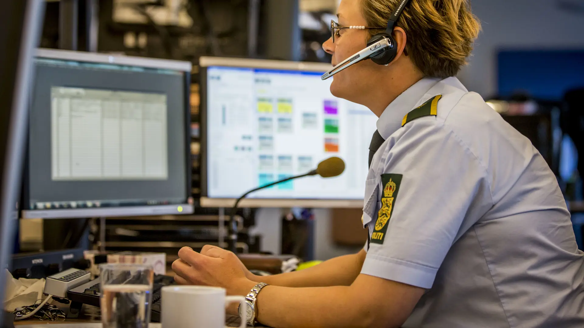 Staff inside the control centre are talking on the phone.