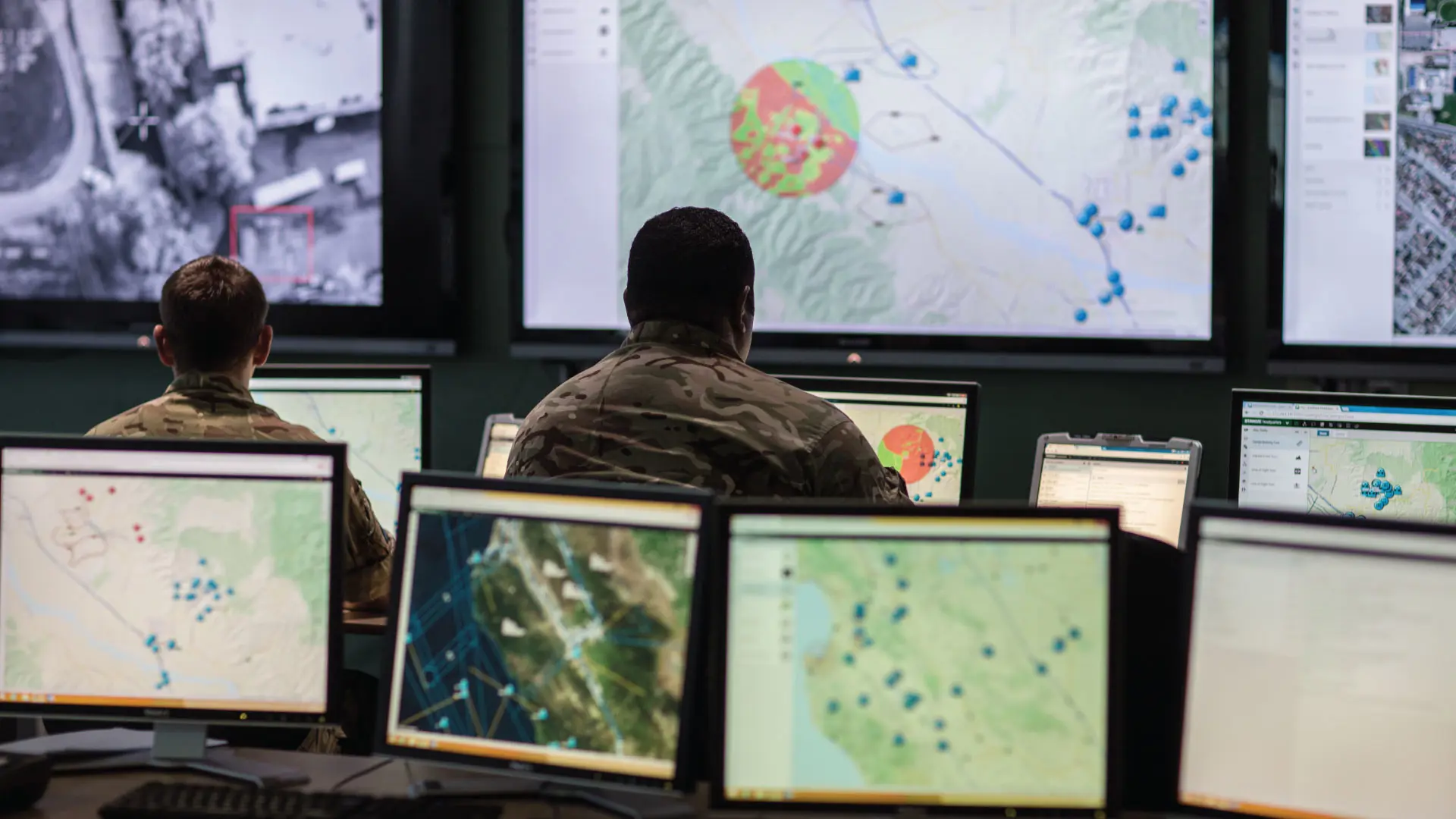 Military men looking at Sitaware Headquarters in war room