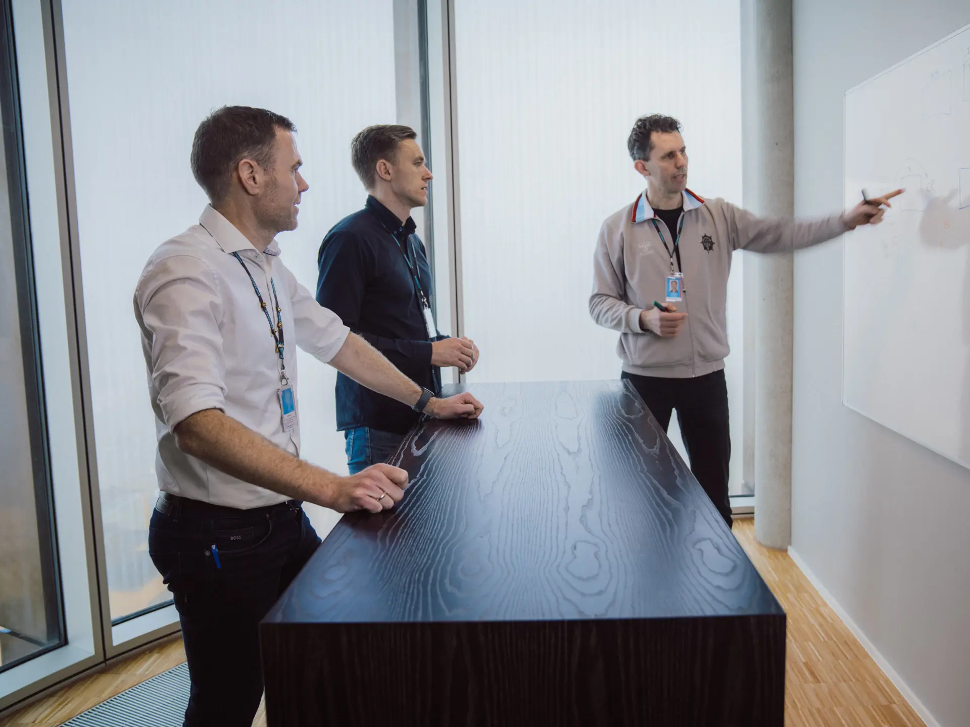 Employees at a whiteboard