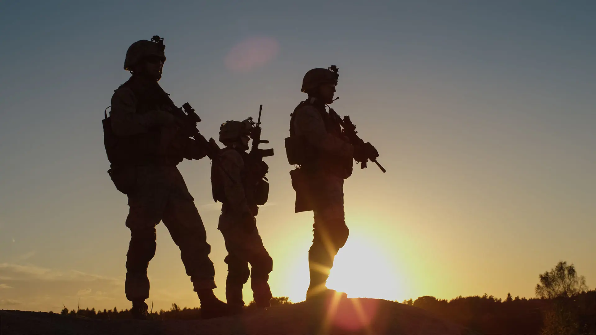 Armed Soldiers On Hill In Sunset