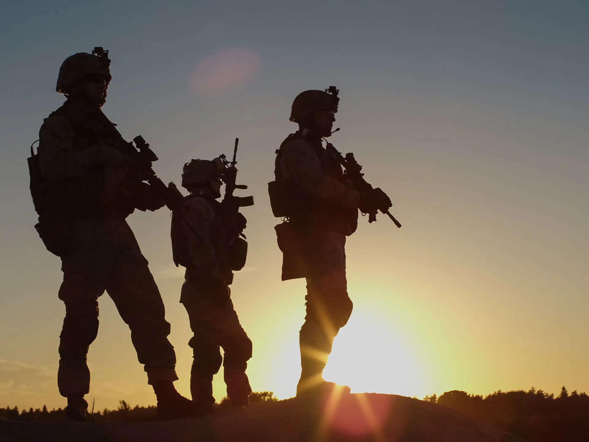 Armed Soldiers On Hill In Sunset
