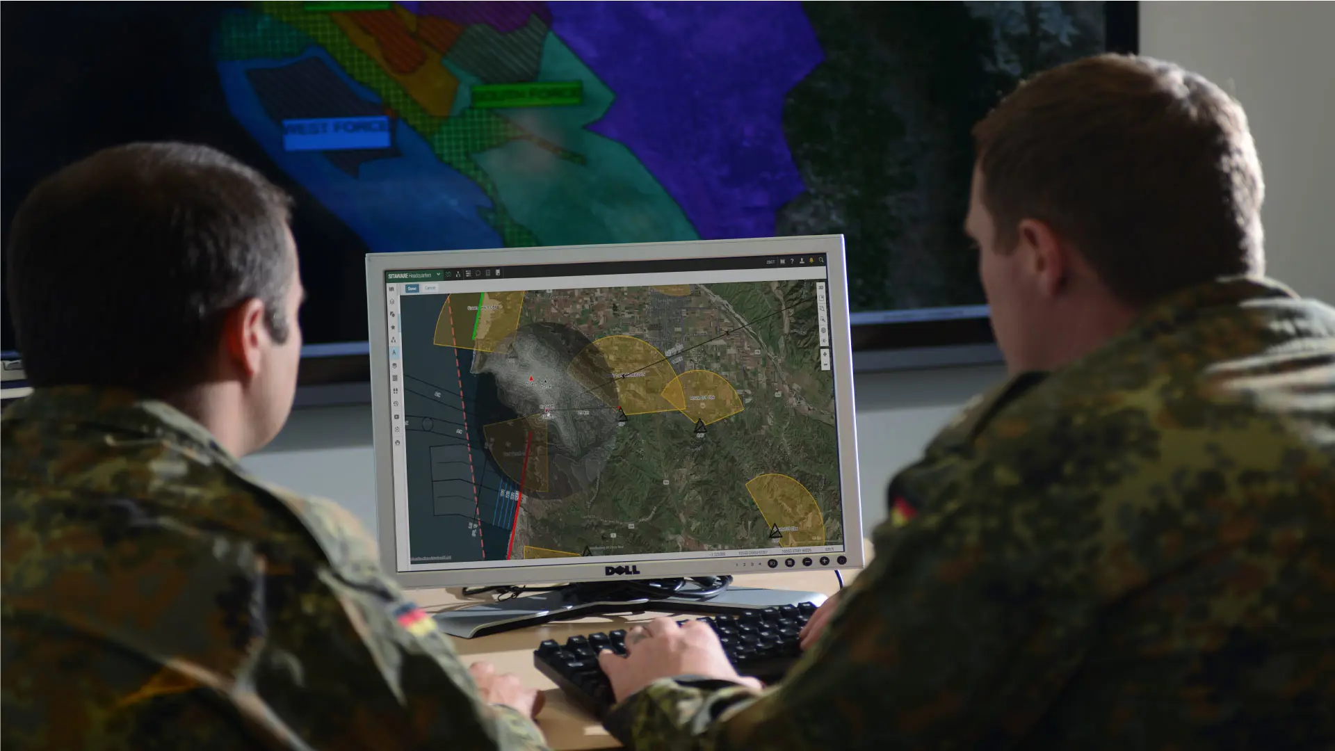 two military students in front of a computer