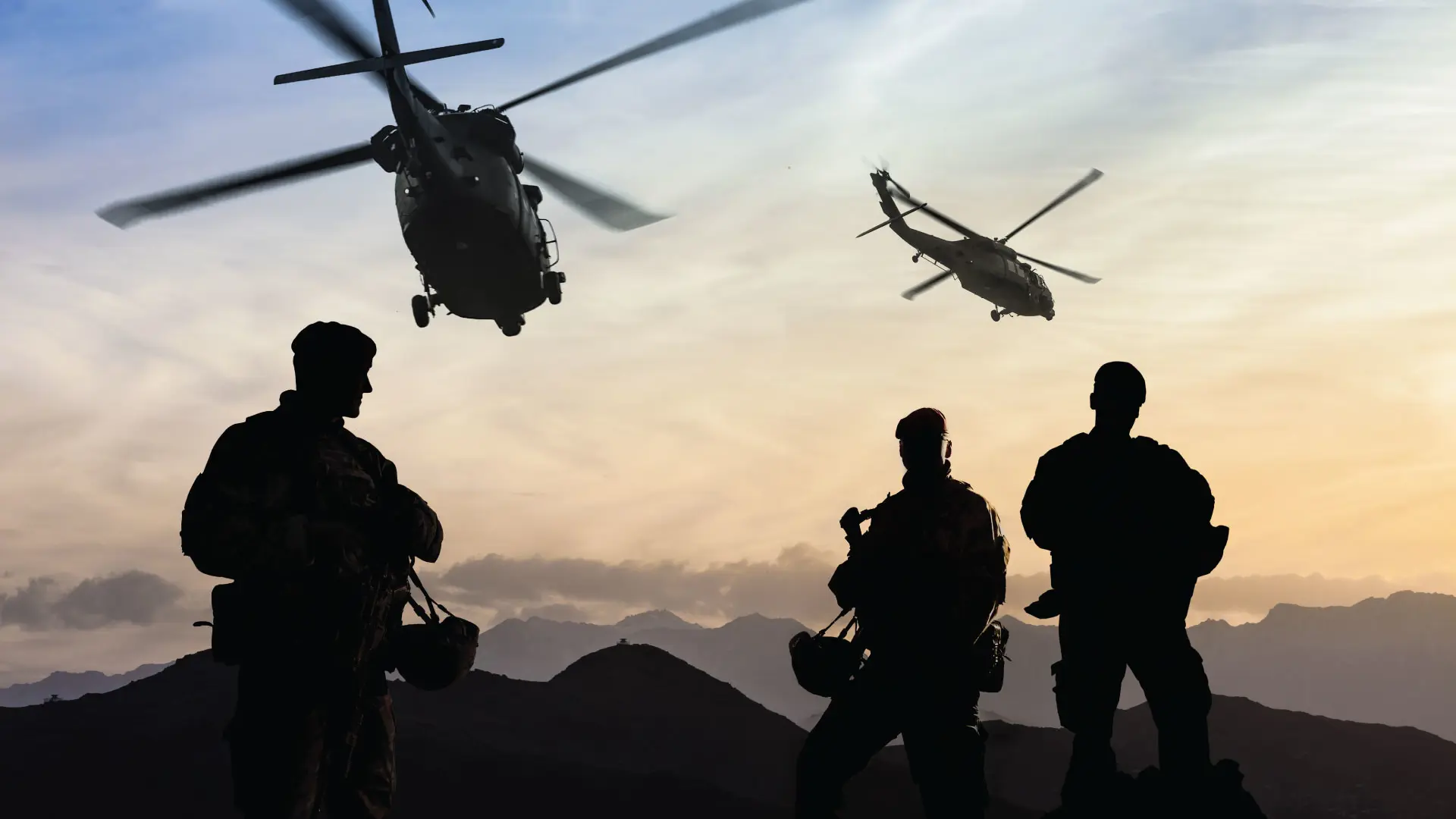 Helicopters flying above soldiers in shadow
