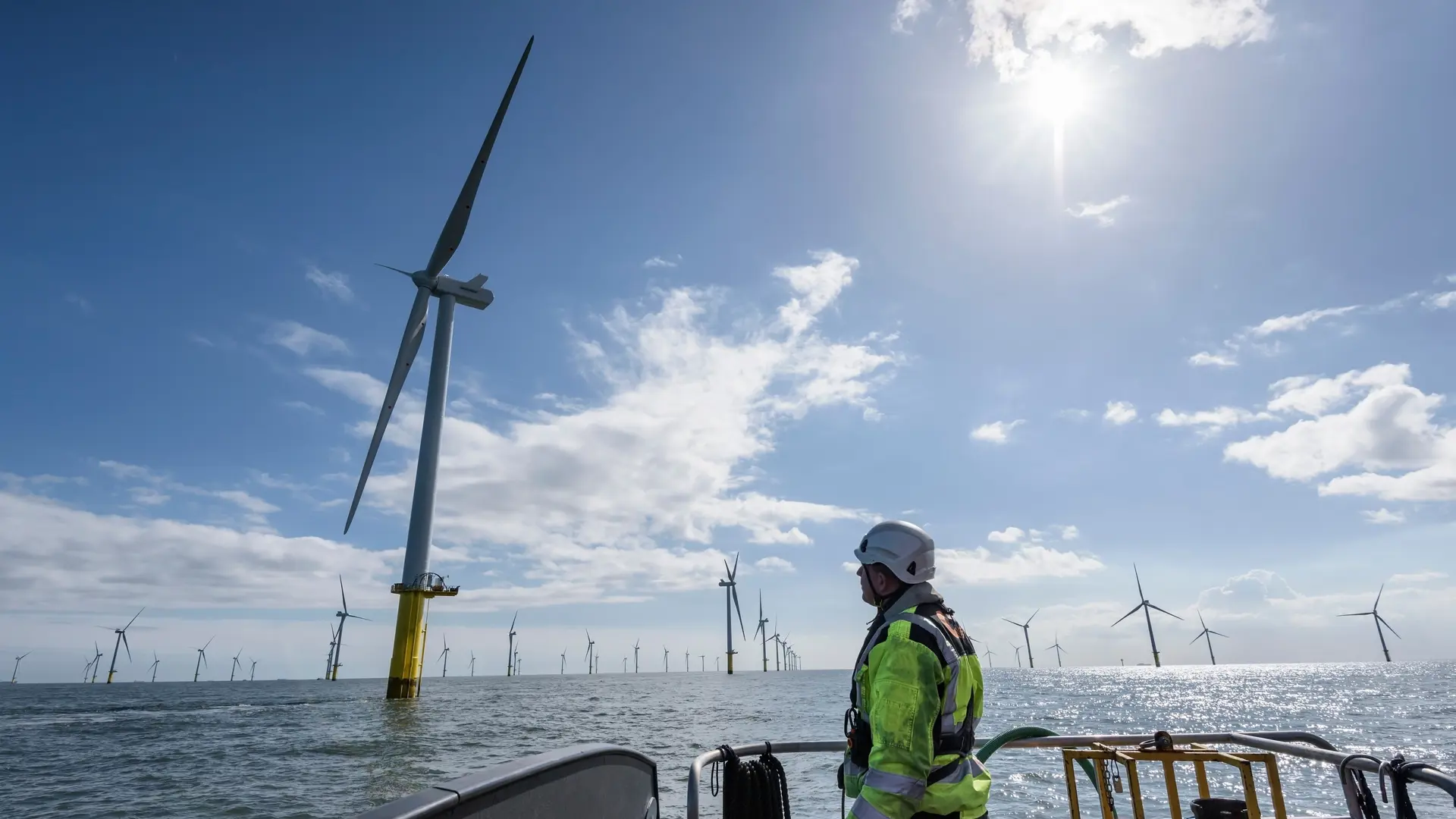 Operator in front of a wind mill