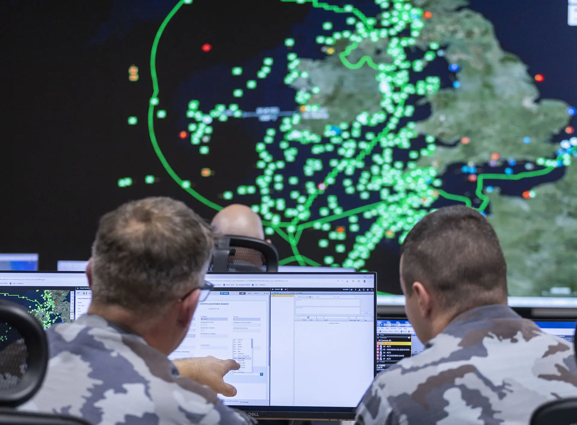 Two men in the military looking at screen