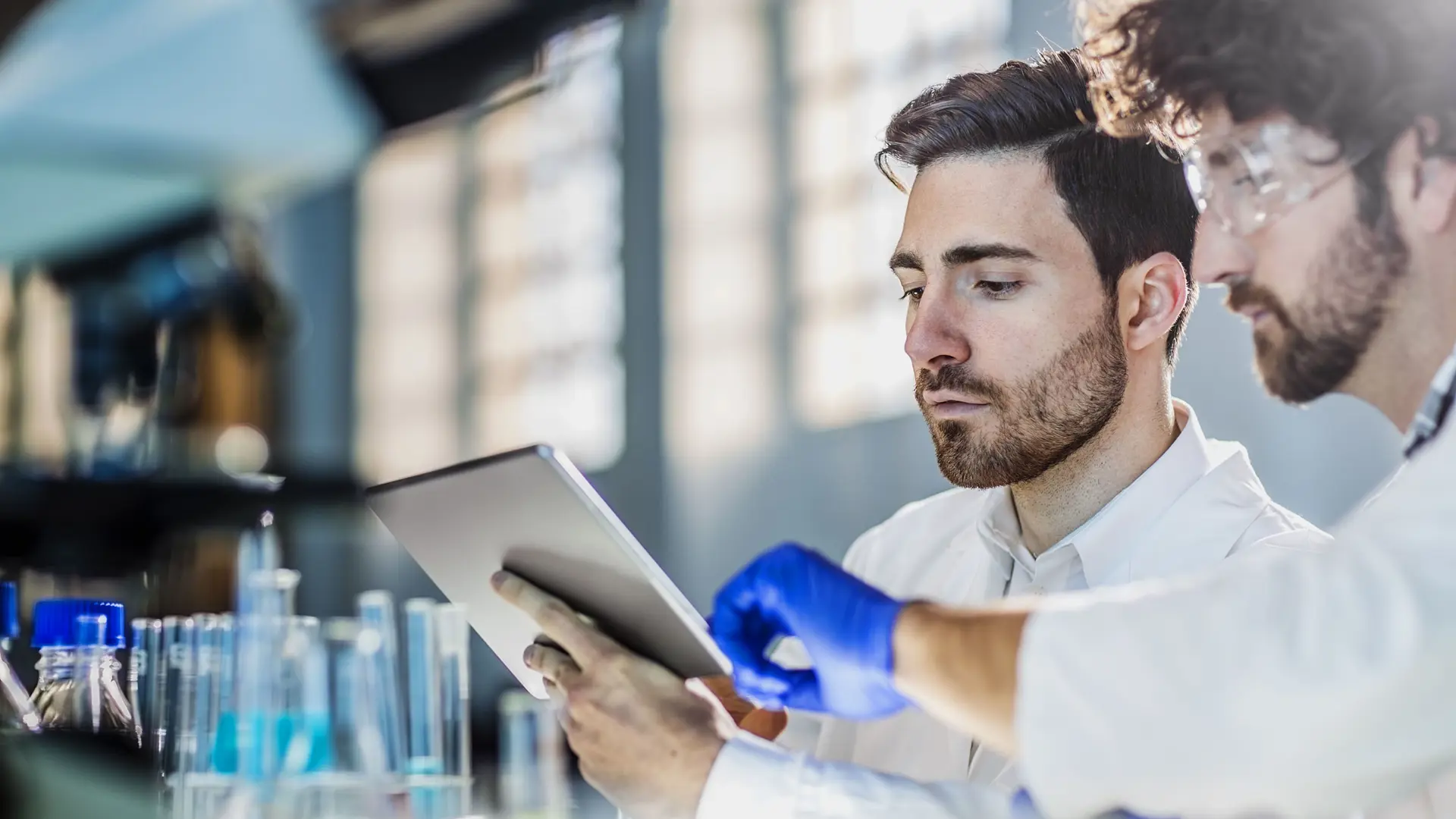 Two Scientist Using Digital Tablet In Laboratory 