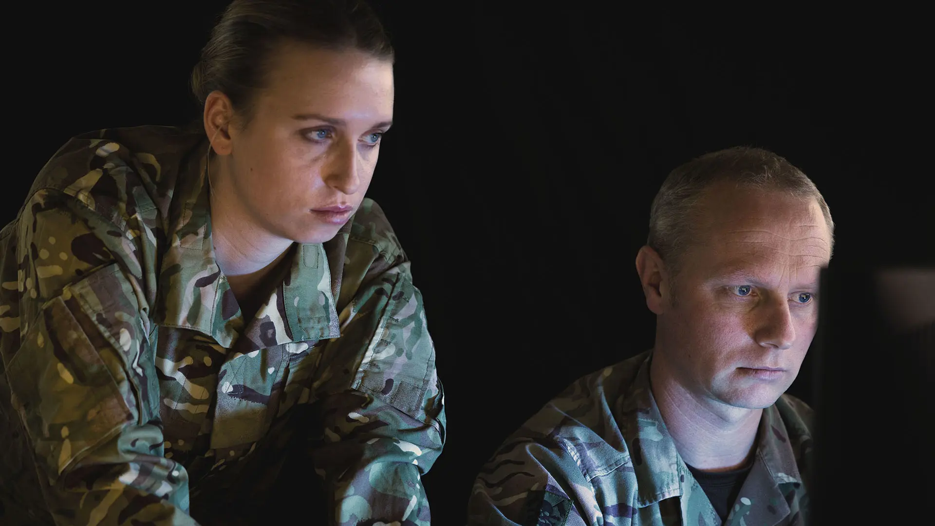 Staff-looking-at-screens-in-the-dark