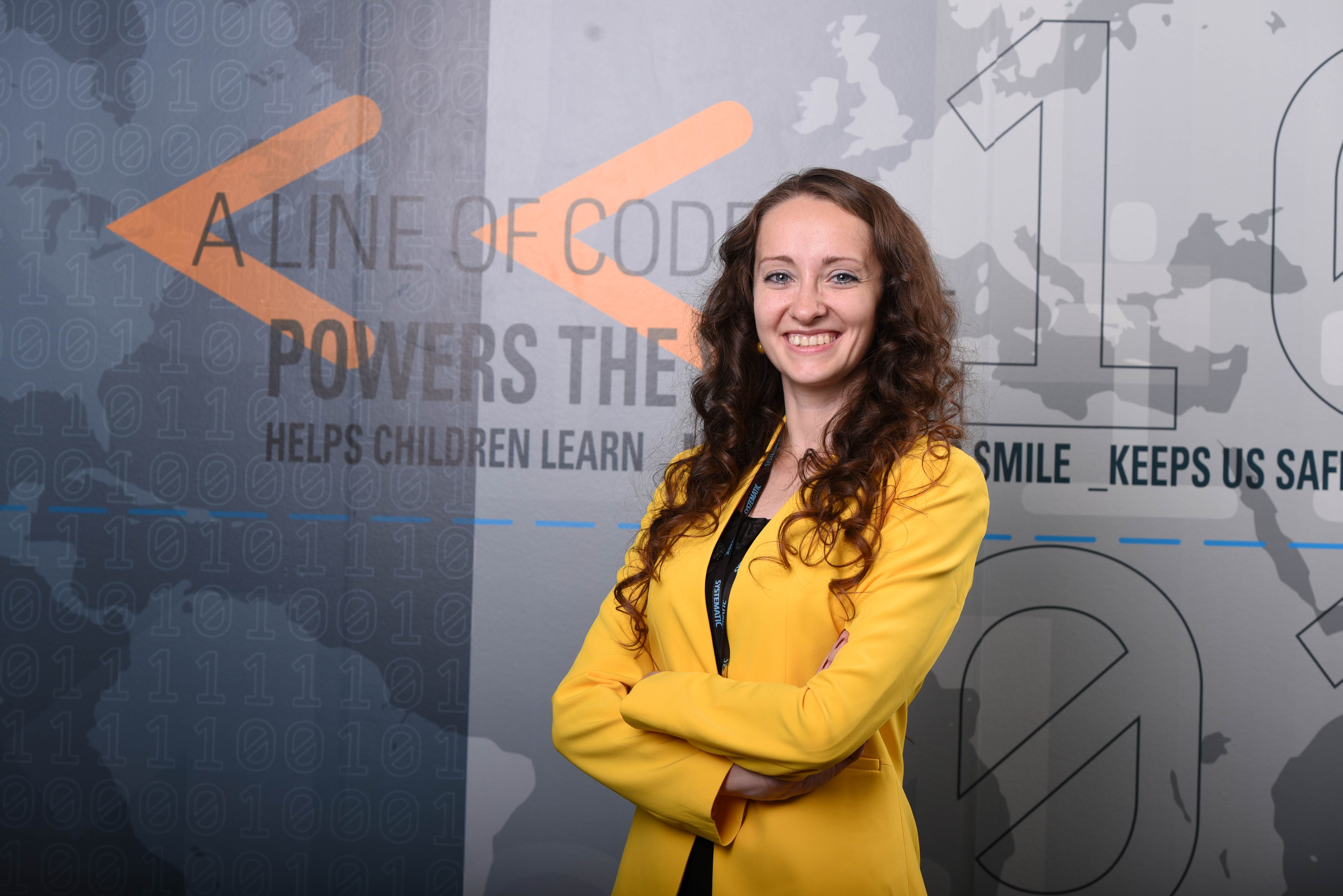 Mihaela Gheorghe-Roman employee standing and smiling